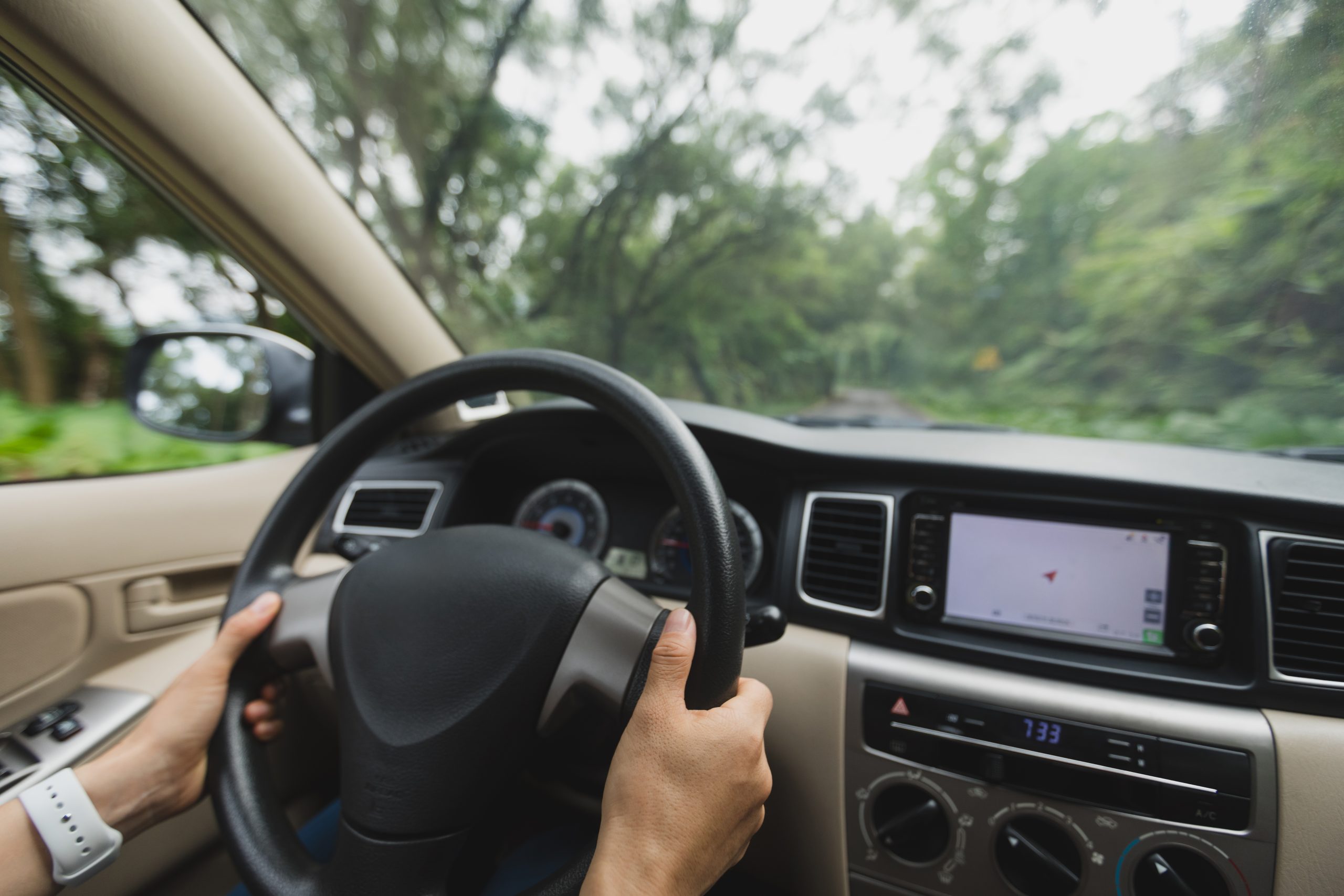 Hands,Driving,Car,On,Mountain,Road Interior of vehicle with person's hands on the wheel, driving